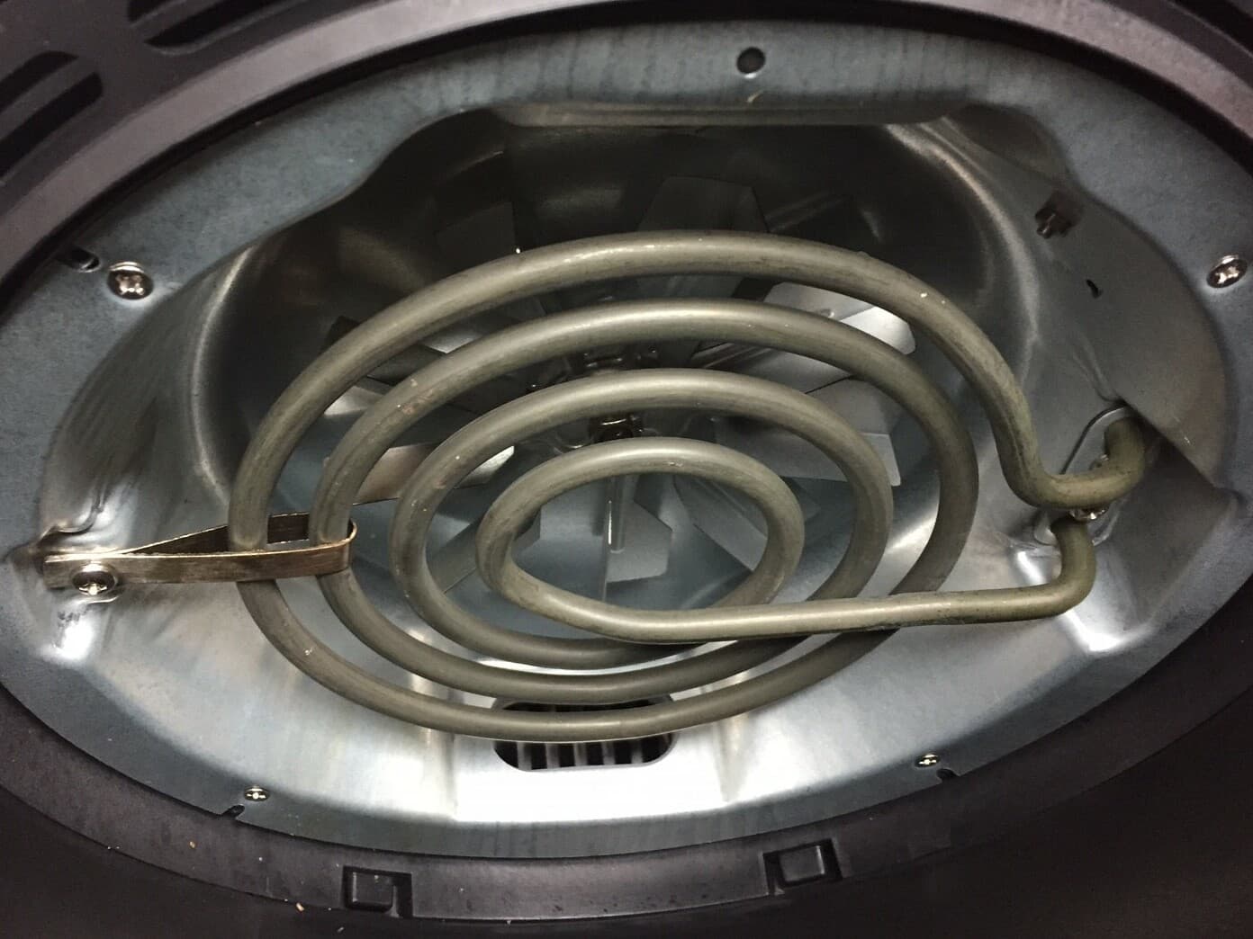 Close-up interior view of an air fryer showing the upper heating element and convection fan