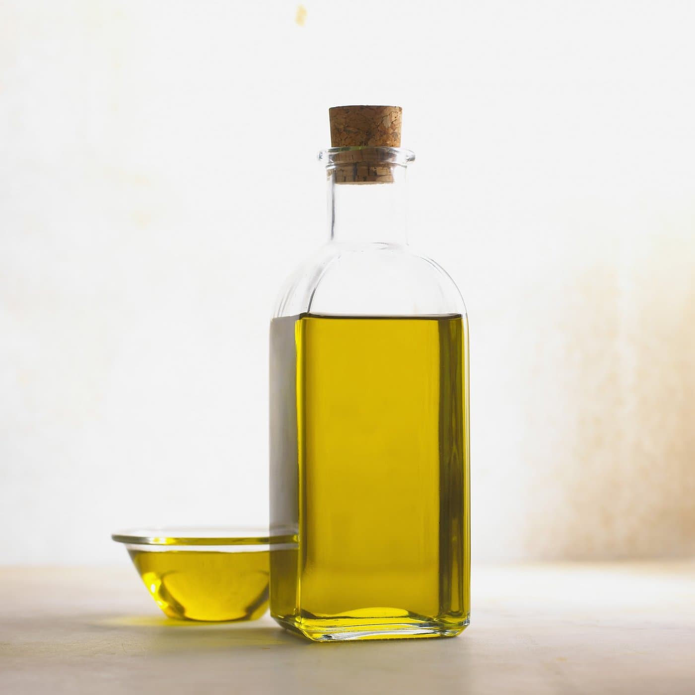 Glass bottle of cooking oil on a kitchen countertop